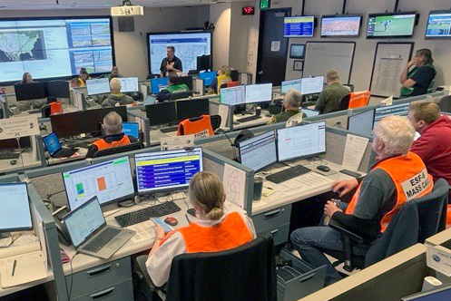 Emergency management team reviewing maps and plans